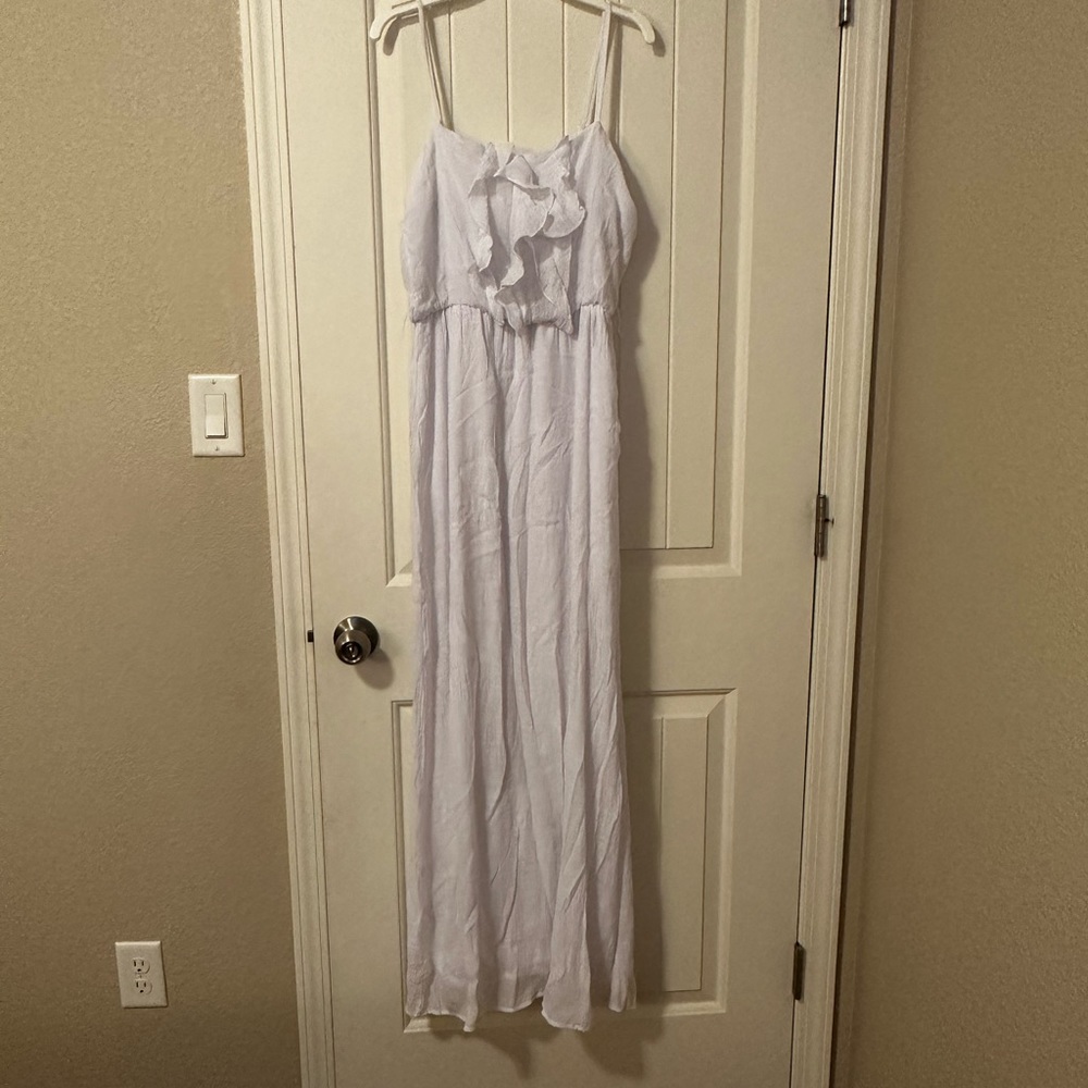 White sundress with thin straps and ruffle front